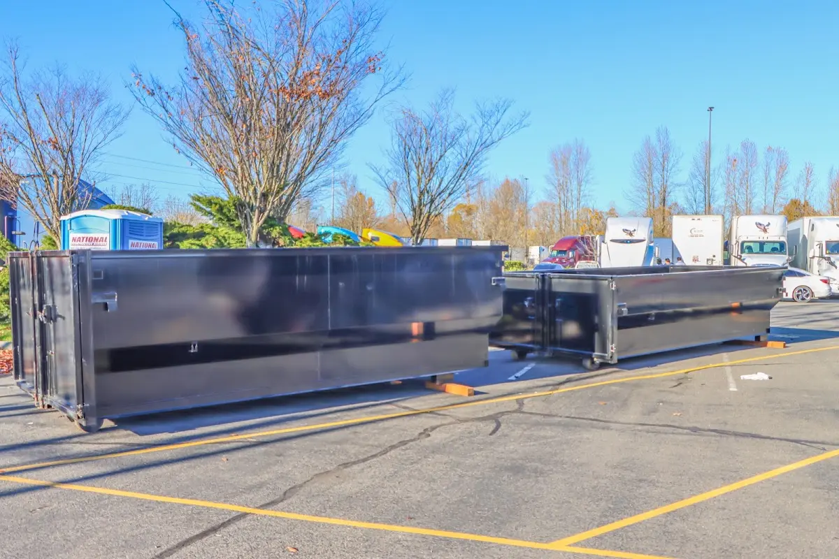 Professional dumpster rental service with roll-off container on residential driveway in Marietta